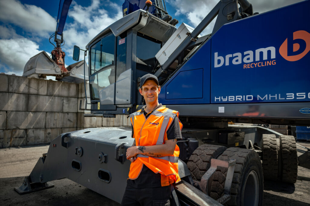 machinist infront of blue machine